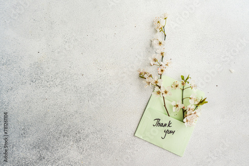 Cherry blossom branches over a thank you card