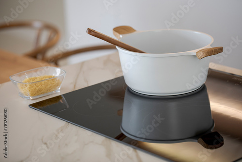 Modern kitchen with induction hob and cooking utensils