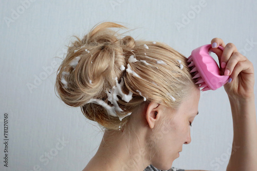 Woman using pink scalp massager for hair growth stimulating. Hair care pink silicone head massager.