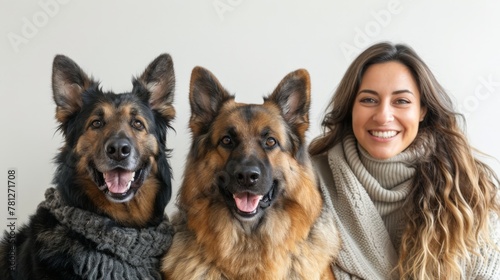 Woman sitting with dogs in scarves