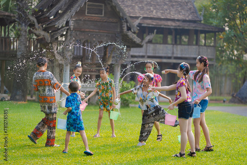 Songkran Water Festival Thailand. Asian young travel group wearing colorful Thai dress according to Thai culture and tradition for the Songkran Festival in Thailand.
