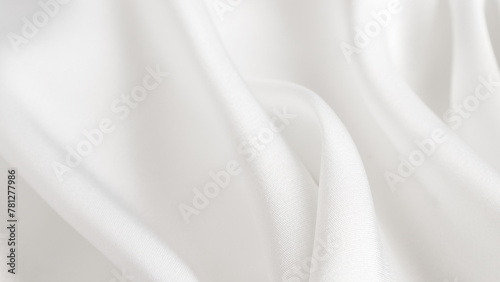 A macro photography shot of a white linen cloth with waves, displaying tints and shades. The pattern resembles automotive design elements, with a touch of peach and transparent materials