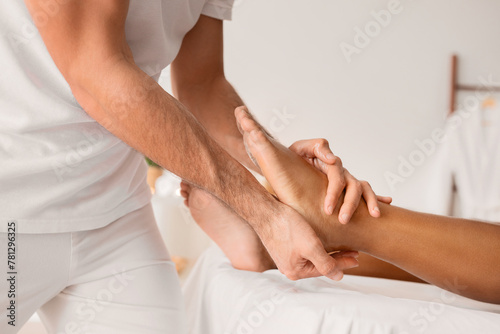 Close-up of man hands giving foot massage