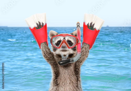 Portrait of a funny raccoon in a diving mask and flippers against the background of a sea