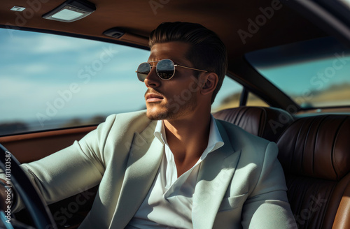 Dapper man in sunglasses driving with open road ahead, stylish and composed. © Sascha