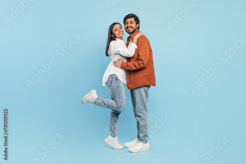 Loving couple embracing and lifting one leg