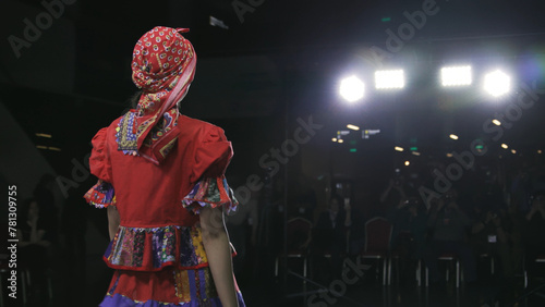Fashion slavic design female clothe folk woman podium slow motion stage. Defile beautiful ethnic girl dress on catwalk model tradition show closeup evening vogue 4K photo