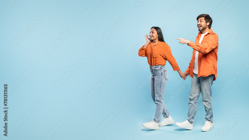 Fototapeta premium Couple pointing to side and looking surprised