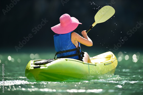 woman paddle her kayak in the sea 