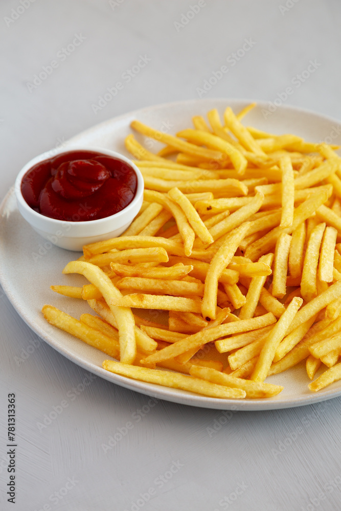 Fried French Fries with Ketchup on a Plate, side view. Fried French Fries with Ketchup on a Plate, side view.
