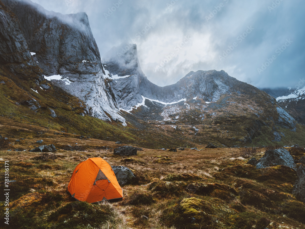 Obraz premium Tent camping in mountains moody nature landscape in Norway Travel in Lofoten islands adventure active summer vacations outdoor climbing gear equipment