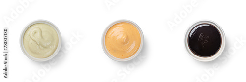Overhead view of side dish of Asian Poke Bowl sauces including spicy mayo, eel sauce and wasabi mayo. With clipping PATH © bartsadowski