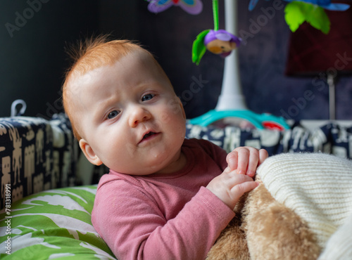 Red haired baby girl playing