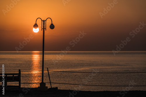 white glowing sun on a lantern during sunrise at the red sea