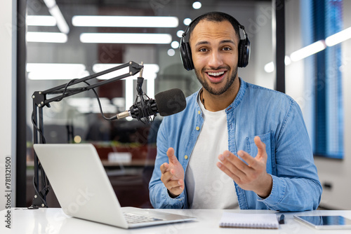 Indian man podcasting from home in a cozy living room setting