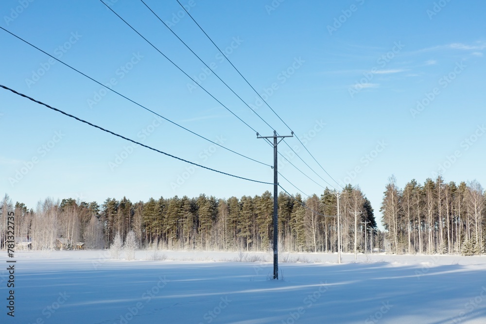 Power lines in clear winter weather with snow on the ground, Loppi, Finland. Power lines in clear winter weather with snow on the ground, Loppi, Finland.