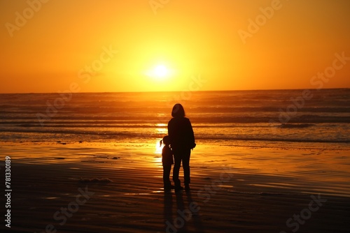A kid and a mother with sunset