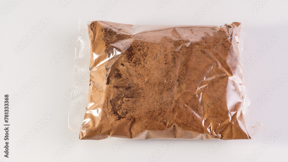 Cocoa powder in a transparent bag on a white background.