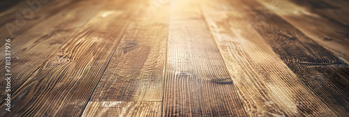 A closeup shot of a brown hardwood plank flooring with a blurred background, showcasing the natural wood grain pattern and beige tones