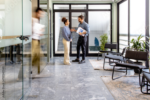 Business partners talking in the hallway after a meeting.