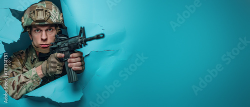 An armed soldier in combat gear peers through a blue paper tear, symbolizing alertness and readiness