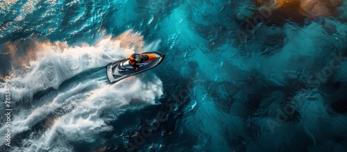Dynamics, speed. Top view of jet ski carving through clear turquoise waters, leaving a frothy trail.