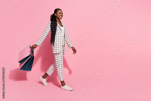 Full size profile side photo of young pretty girl go shop mall look empty space discount isolated over pink color background