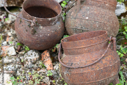 Wallpaper Mural Three aged and ferrous iron pans. Kitchen utensils for cooking meals over a fireplace in a rural context. Torontodigital.ca