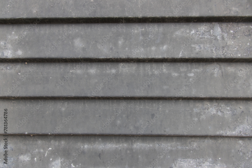 Detail of a metal door with recesses painted gray and dirty with dust. Background image Detail of a metal door with recesses painted gray and dirty with dust. Background image