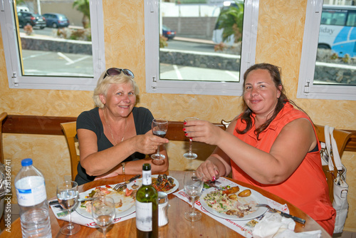 Women are having dinner at resort restaurant.