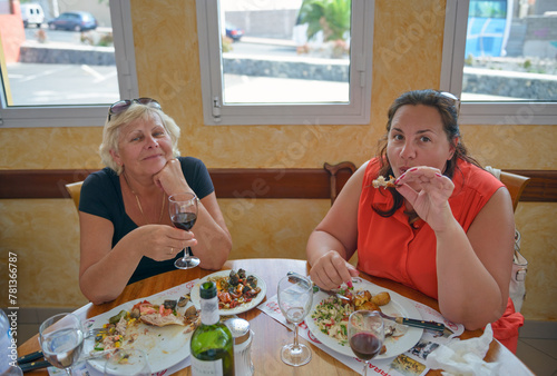 Women are having dinner at resort restaurant.