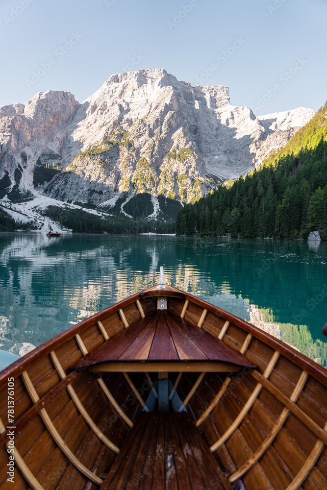 View of wooden boat on Lake di Braies with beautiful mountains in the background, Dolomites. Italy