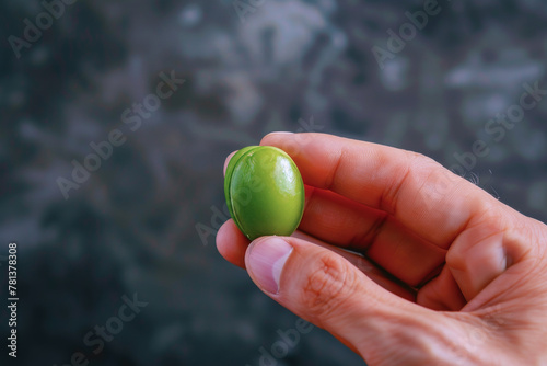 Hand holding green pea isolated with copy space, healthy food