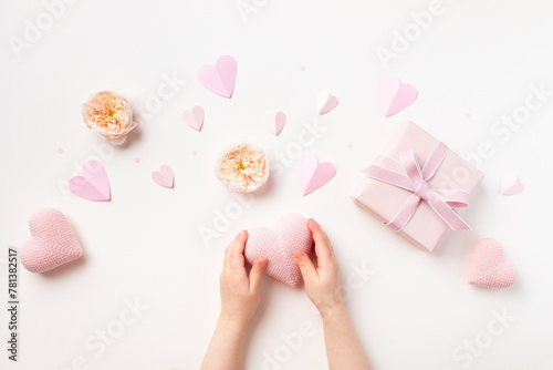 Child hands with gift or present box decorated with pink hearts and rose flowers for Happy mothers day. Holiday greting card. © juliasudnitskaya