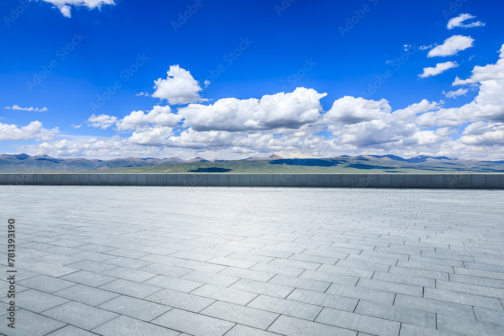 Empty square floor and mountains with sky clouds on a sunny day
