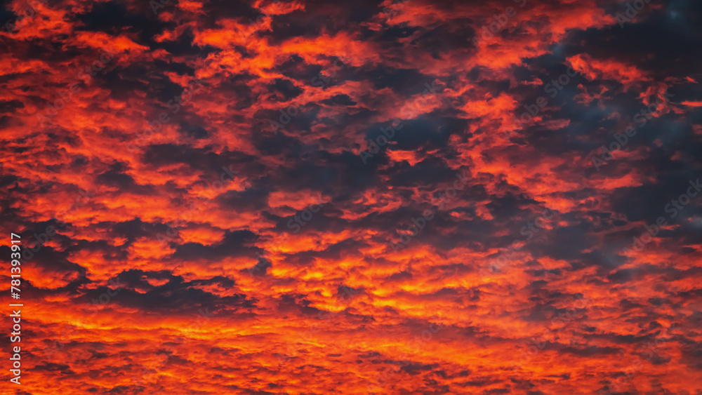 Beautiful view of sunset sky after sun has gone below the horizon. Only the sky above the horizon. Cirrus low clouds. Dramatic sunset. Fantastic dark blue thunderclouds at sunset, Natural composition.