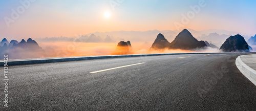 Asphalt highway road and karst mountain with sky clouds natural landscape at sunrise. Panoramic view.