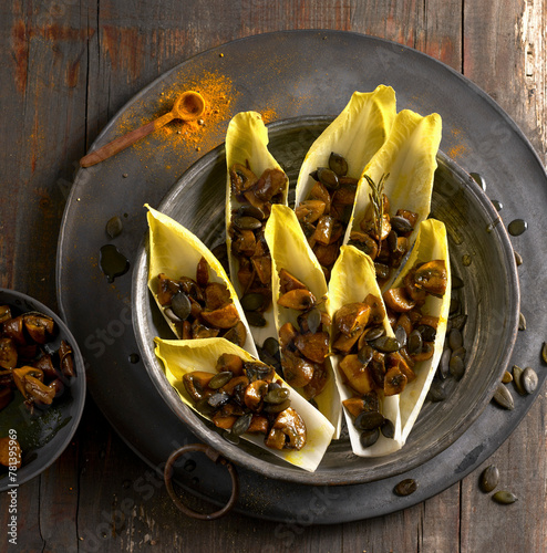 Chicory boats with braised curry mushrooms and pumpkin seeds photo