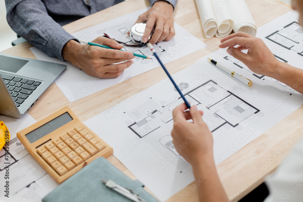 Architects at a meeting discussing house plans are reviewing draft house plans. Projects assigned by customers and customized design before delivery Interior design and decoration ideas Architects at a meeting discussing house plans are reviewing draft house plans. Projects assigned by customers and customized design before delivery Interior design and decoration ideas