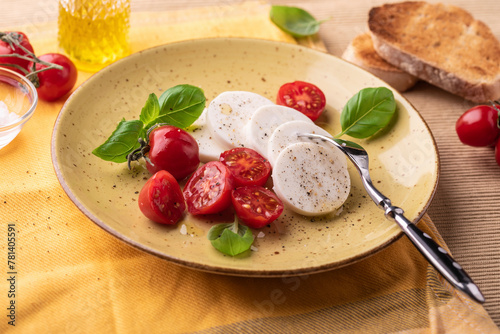 Vegan 'Mozzarella' with olive oil, tomatoes and basil photo