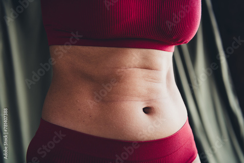 Cropped unretouched photo of girl with stretch marks fitness motivation concept isolated green line background