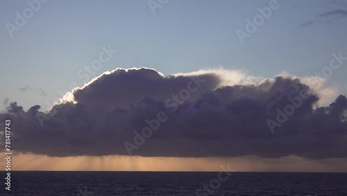 Rain clouds with a silver lining at sunset over the Bay of Biscay, Portugal