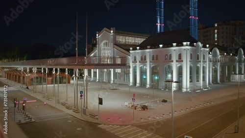 Building of the House of Culture GES-2 at night in Moscow, Russia. View near the river with a sculpture. High quality 4k footage photo