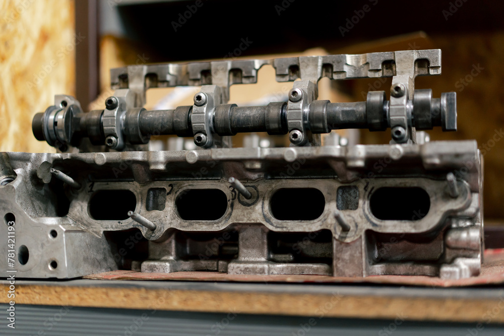 Disassembled car engine Cylinder head of automobile engine Repaired car inside Sixteen valves View from above