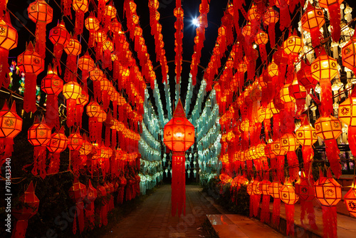 Colorful illuminated lantern tunnel at night during Loy Krathong festival in Thailand.