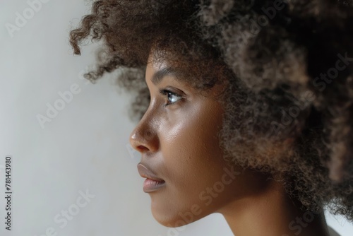 Profile image capturing the beauty and texture of a woman's voluminous curls against a soft background photo