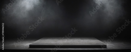 A dark room with a wooden floor and smoke in the air. Spotlights are shining down from above.