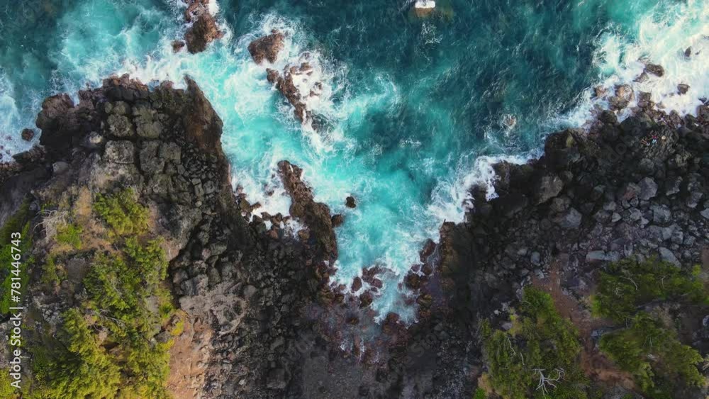 Aerial top-down view of waves hitting against the shore, Reunion