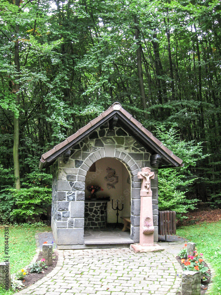 A small fairy tale like chapel in the woods at Arensberg in the Vulcaneifel geopark in Germany