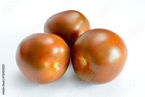 three brown tomatoes isolated on white background close up